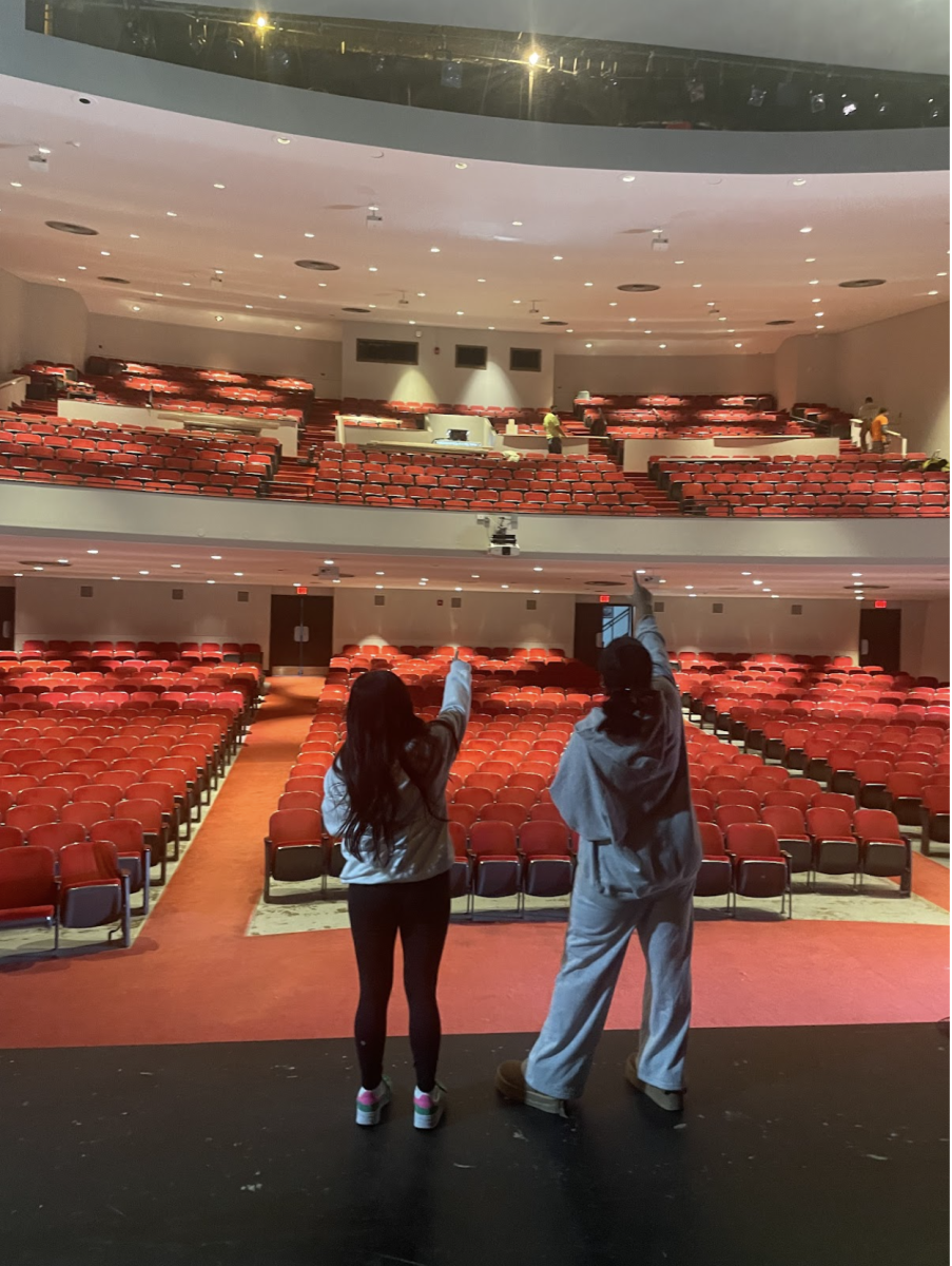 Katelyn Hernandez (senior) and Matipa Marimbe (senior) recreating the golden globes in the auditorium. 
